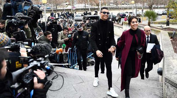 Sonriente, con anteojos oscuros, traje negro y zapatillas blancas, Ronaldo acudió a la audiencia acompañado de su pareja. Foto: AFP