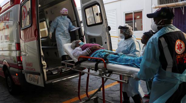 Profesionales de la salud ingresan a la ambulancia a un paciente con síntomas de covid-10. Foto: Reuters
