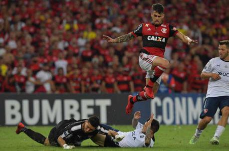 Felipe Vizeu del Flamengo disputa una pelota ante Martin Campana. Foto: AFP